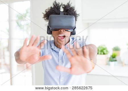 African amaerican man having fun playing with virtual reality glasses