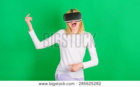 Amazed Young Woman Touching The Air During The Vr Experience. Pretty Woman Playing Game In Virtual R