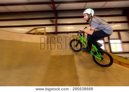 Man Jumping And Riding On A Bmx Bicycle At An Extreme Sports Park