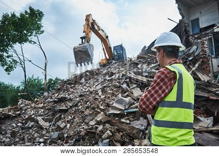Demolition construction work. Worker at building site