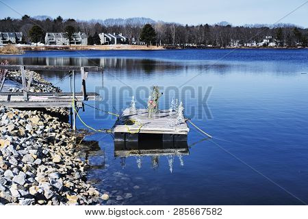 A Small Floating Dock With Christmas Reindeer Decoration On The Batson River In Kennebunkport, Maine