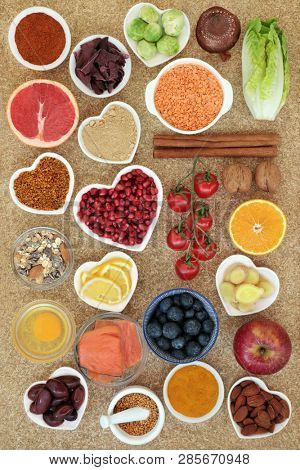 Healthy food to slow the ageing process concept with fruit, vegetables, fish, nuts, spices, dairy, supplement powders & pollen grain. Very high in antioxidants, anthocyanins, dietary fibre & vitamins.