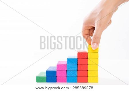 Concept Of Building Success Foundation. Women Hand Put Wooden Blocks In The Shape Of A Staircase.