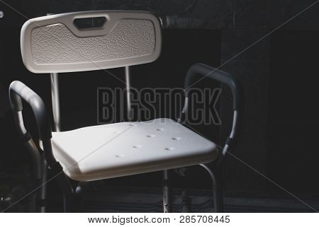 Plastic Bathing Chair For Elder Or Disabled People Showering Put In Dark Letting Light Come From Lef