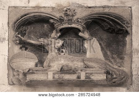 Symbol Of The Dominican Order. Picture (bas-relief) Of A Dog That Holds A Burning Torch In The Teeth