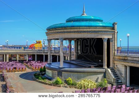 Eastbourne, Sussex, Uk - August 1, 2018: Art Deco Band Stand With Seating. Taken On A Sunny Blue Sky