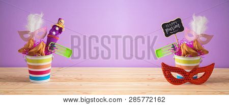 Jewish Holiday Purim Background With Bucket, Carnival Mask, Noisemaker And Hamantaschen Cookies On W