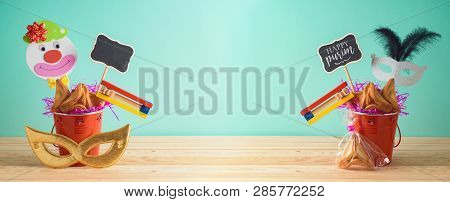 Jewish Holiday Purim Background With Bucket, Carnival Mask, Noisemaker And Hamantaschen Cookies On W