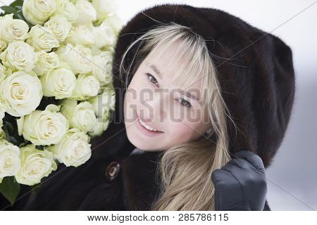Happy Woman With A Bouquet Of Flowers
