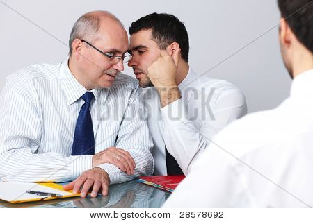 Senior and young colleague interview applicant for a job