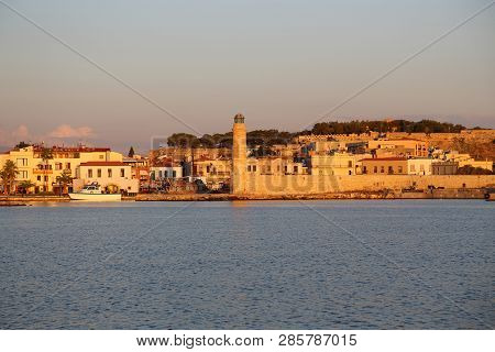 A beautiful view of harbour in Rethymno with lighthouse and fortress Fortezza at sunrise, Crete island, Greece
