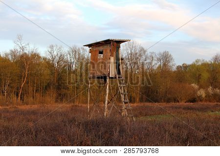 Makeshift Old Dilapidated Hunting Observation Tower With Cracked Wooden Boards And Improvised Wooden