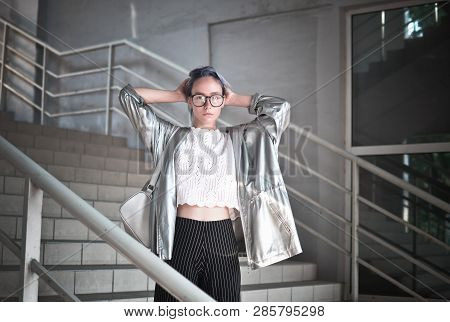 Extraordinary Hipster Girl With Ashen Blue Hair Is Dressed In A Cloak With A Silvery Fabric And A Ba