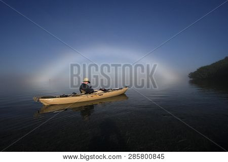 Key Biscayne, Florida 01-16-2016 Kayaker Enjoys A Bright Fogbow Ober Biscayne Bay On A Calm, Foggy M