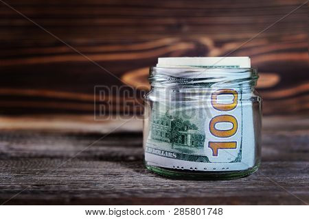 Saving Money In Jar With American Dollars , Cash