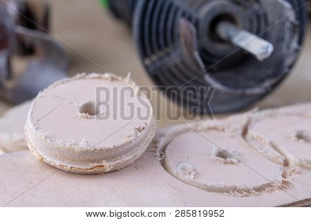 A device for making holes in wood. Joinery accessories for DIY enthusiasts. Dark background.