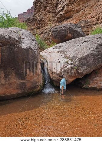 Young Woman Enjoys Some Downtime In Hermit Creek During A Multi-day Backpacking Expedition On The He