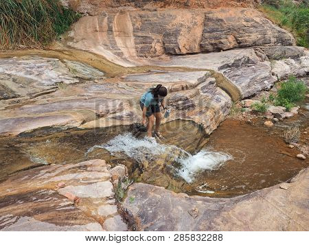 Young Woman Enjoys Some Downtime In Hermit Creek During A Multi-day Backpacking Expedition On The He