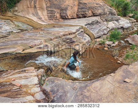 Young Woman Enjoys Some Downtime In Hermit Creek During A Multi-day Backpacking Expedition On The He