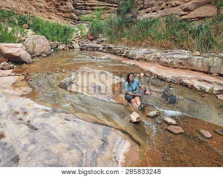 Young Woman Enjoys Some Downtime In Hermit Creek During A Multi-day Backpacking Expedition On The He