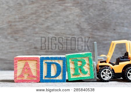 Toy Forklift Hold Letter Block R To Complete Word Adr (abbreviation Of Adverse Drug Reaction) On Woo