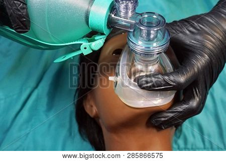 Medical Stuff In Black Gloves Performing Artificial Ventilation Using Bag Valve Mask (ambu Bag) On A