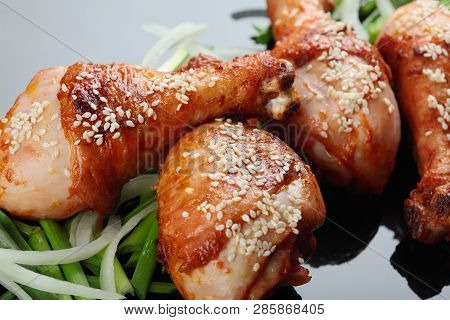 Roasted Chicken Legs On The Miror Background. On The Green Onion.closeup