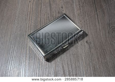 Cigarette With Cigarette Case On An Old Wooden Table.
