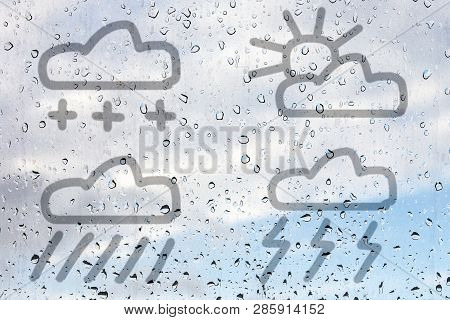 Figure Of Four Weather Symbols, Drawn With A Finger On The Misted Glass. Rain, Sleet, Lightning Rain