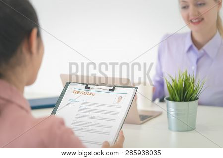 Job Interview, Focus On Resume Document On A Woman Candinate Hand