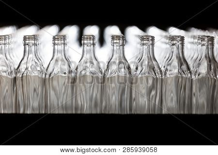 Many Bottles On Conveyor Belt In Glass Factory