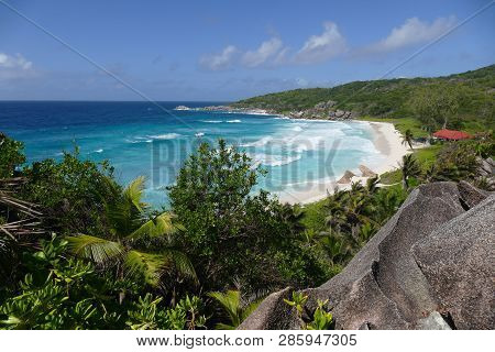 Paradisiacal Landscape Of A Tropical Beach With White Sand And Turquoise Water In Seychelles