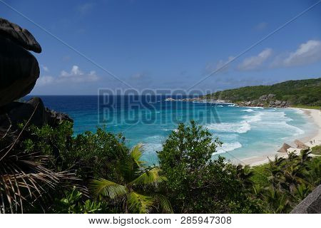 Paradisiacal Landscape Of A Tropical Beach With White Sand And Turquoise Water In Seychelles
