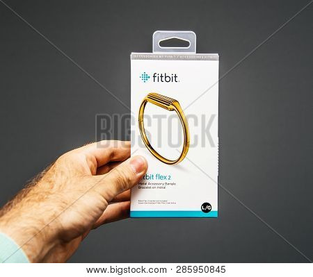 Paris, France - May 30, 2018: Male Hand Holding Fitbit Wristband Metal Gold Plated Accessory Bangled