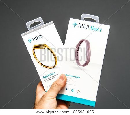 Paris, France - May 29, 2018: Male Hand Holding Fitbit Flex And Fitbit Flex Wristband Female Sports 