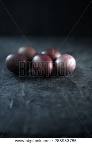 Dark Purple Eggs On A Rough Cement Background.