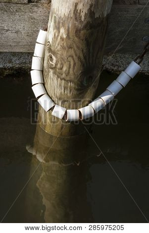 Plastic Sleeves Over Chain Enabling Dock Movement With Little Wear To Chain And Piling