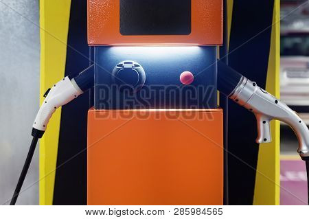 Electric Car Fast Charging Station At Indoor Underground Parking. Power Supply Point Network For Hyb