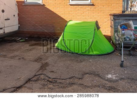 Luminous Green Small Tent Set Up In Any Alleyway By A Homeless Person.