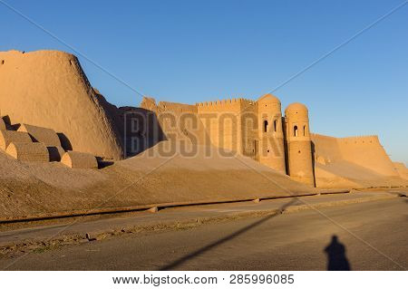 Shadow Of A Photographer In Front Of Ichan Kala City Wall And South Gate During Sunset - Khiva, Uzbe