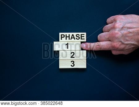 Wooden Blocks Form The Words 'phase, 1, 2, 3,' On Black Background. Male Hand. Beautiful Background.