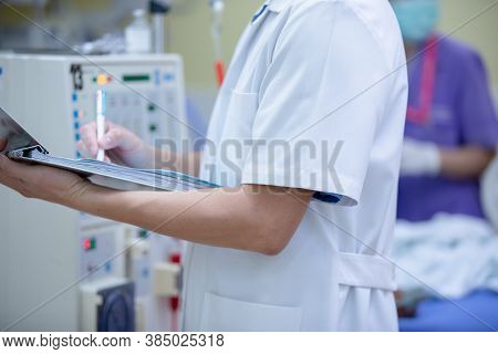 The specialist are checking continuous renal replacement therapy equipment and injection pump and he