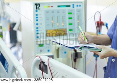 The specialist are checking continuous renal replacement therapy equipment and injection pump and he