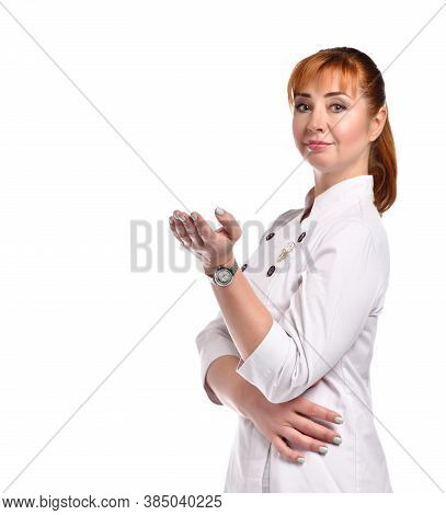Side Shot Of Positive Smiling Red-haired Woman Doctor Or Nurse Turning Head To Camera And Holding Ha