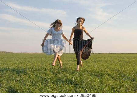 Two Girls Running On The Field
