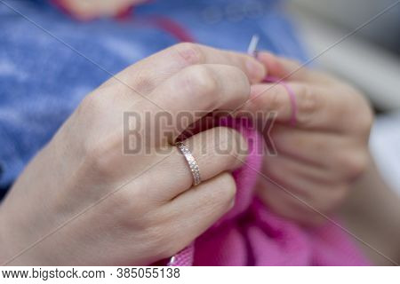 Woman Knits With Knitting Needles Light Pink Sweater From Natural Woolen Threads Wintertime Hobby On
