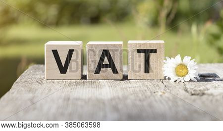 Vat On Wooden Cubes Over Blur Background With Copy Spcae, Financial Concept Background