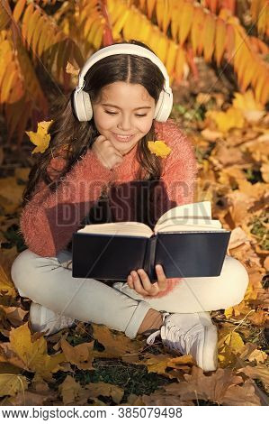 Activate Listening. Small Child In Headphones Practice Listening Comprehension. Little Girl Read Boo