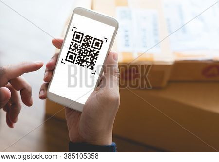 Online Shopping Concepts With Youngman Using Smartphone With Qr Code On Product Package Box.e Commer