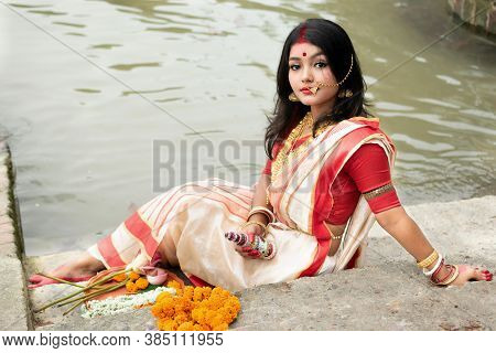 Portrait Of Beautiful Indian Girl In Front Of Ganga River Wearing Traditional Indian Saree, Gold Jew